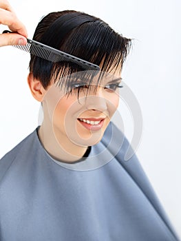 Hair. Hairdresser doing Hairstyle. Beauty Model Woman. Haircut.