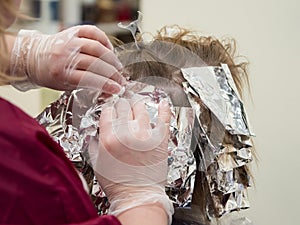 Hair highlights in the beauty salon. photo