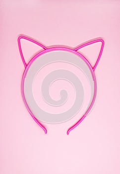 Hair hoop in shape of cat ears on soft pink background