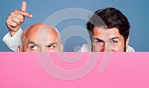 Hair loss, baldness. Middle aged and senior bald man face close up. Copy space for text. Paper baner, blackboard.