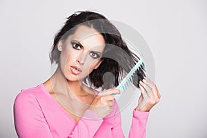 Hair loss woman with a comb and problem hair. Hairloss and hairs problems. Sad girl with damaged hair. Tangling hairs