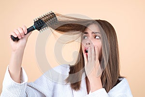 Hair loss woman with a comb and problem hair. Hairloss and hairs problems. Sad girl with damaged hair. Haircare and loss