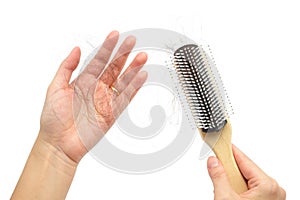 Hair loss in woman hands and brush