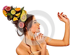 Hair mask from fresh fruits on woman head and spring flowers.