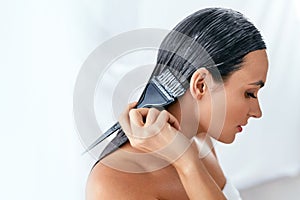 Hair Mask. Woman Applying Conditioner On Long Hair With Brush, Hair Care Treatment