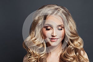 Hair model. Woman face with long healthy wavy hair on black background