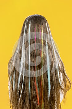 Hair with multi-colored strands. Teenage hairstyle. Highlighting. Rebellious style.