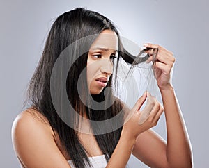 Hair problem, damage and woman in studio with worry for split ends, haircare crisis and weak tips. Beauty, salon and