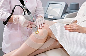 Hair removal cosmetology procedure from a therapist at cosmetic beauty spa clinic