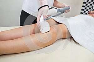 Hair removal on the legs, laser procedure at medical clinic