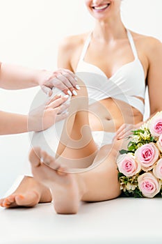 Hair removal using wax strips at the legs in beauty parlor