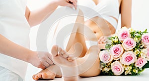 Hair removal using wax strips at the legs in beauty parlor