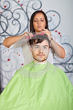 Hair salon. Hairdresser does haircut for man.