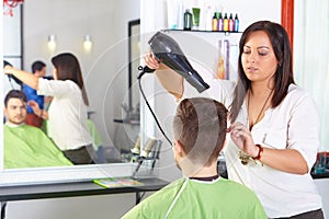 Hair salon. Men`s haircut. Use of hair dryer.