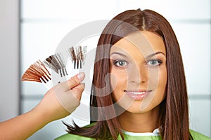 Hair salon. Woman choses color of dye.