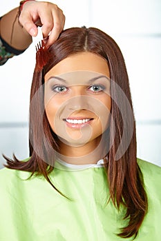 Hair salon. Woman choses color of dye.