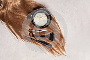 Hair, scissors, comb, brush and hair dye on white background. Hairdresser and barber equipment, top view