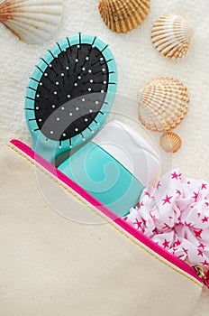 Hair shampoo (mask, conditioner, face cream, sunscreen lotion), hair brush and scrunchie in a make-up pouch.