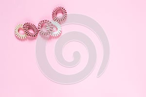 Hair spiral scrunchies on pink background