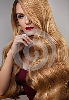 Hair Style. Beautiful Woman With Healthy Wavy Long Blonde Hair