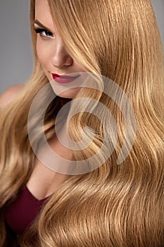 Hair Style. Beautiful Woman With Healthy Wavy Long Blonde Hair