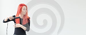 Hair style, hairdresser and people concept - stylish red-haired woman with curling iron on white background banner with