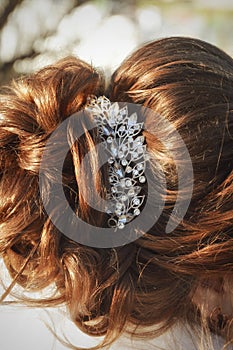 Hair styling. Festive hairstyle for the bride. Hair with a beautiful barrette.