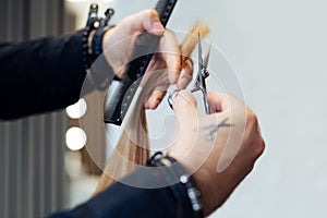 Hair stylist cutting woman`s hair