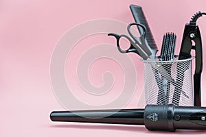 hair stylist tools in a basket. scissors, brush, comb. curling iron