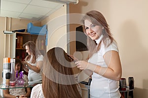 Hair stylist work on woman