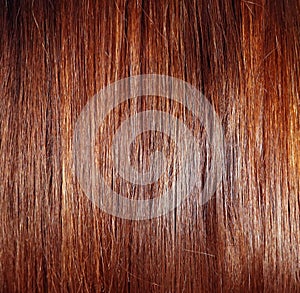 Hair texture close up chestnut golden brown color, closeup view of bunch of reddish auburn straight brown hair
