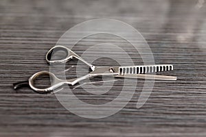 Hair thinning scissors on table in professional hairdressing salon. Selective focus