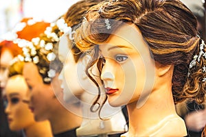 hair wig head hairdresser mannequin rows on display on some dummies in a store