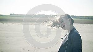 Hair in the wind. A young cheerful girl, beautifully dancing in the open countryside. slow motion