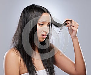 Hair, worry and woman with crisis in studio for split ends, haircare crisis and weak tips on gray background. Beauty