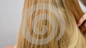 Haircare. Beautiful healthy straight hair. Woman shakes blonde long hair