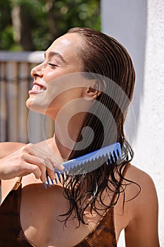 Haircare. Closeup Of Female Model Brushing Beautiful Long Healthy Hair