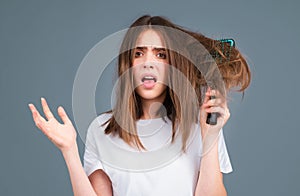 Haircare. Straightening woman with straight brushed hair. Hair tangling problem. Unhappy girl with tangled hair. Damaged