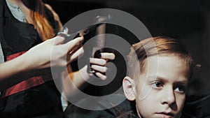 Haircut for boy trimmer for hair and comb at the hairdresser.