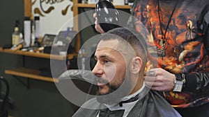 Haircut men Barbershop. Men's Hairdressers; barbers. Barber cuts the client machine for haircuts.