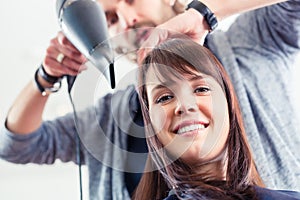Hairdresser blow dry hair in shop