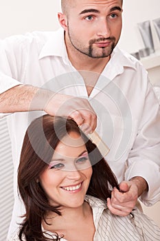 Hairdresser comb customer at salon