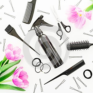 Hairdresser concept with spray, scissors, combs, barrette and tulips flowers on white background. Beauty feminine concept. Flat