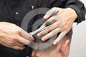 Hairdresser cuts men`s hair cut