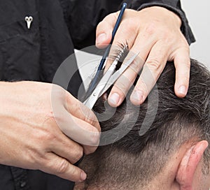 Hairdresser cuts men`s hair cut