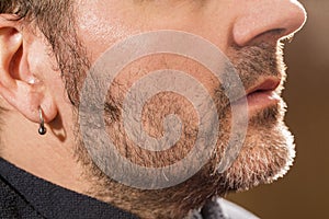 Hairdresser, cutting beard in her work place