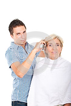 Hairdresser cutting woman hair