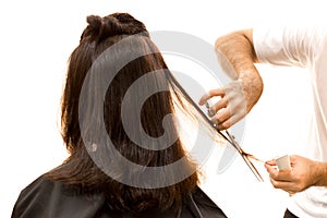 Hairdresser cutting woman hair with scissors isolated