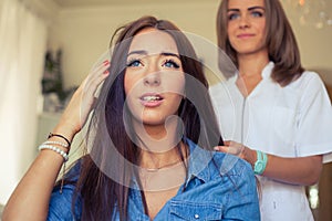 Hairdresser doing haircut for women in hairdressing salon. Concept of fashion and beauty. Positive emotion.