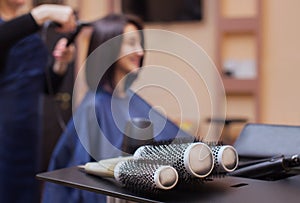 The hairdresser dries her hair a brunette girl in a beauty salon. photo